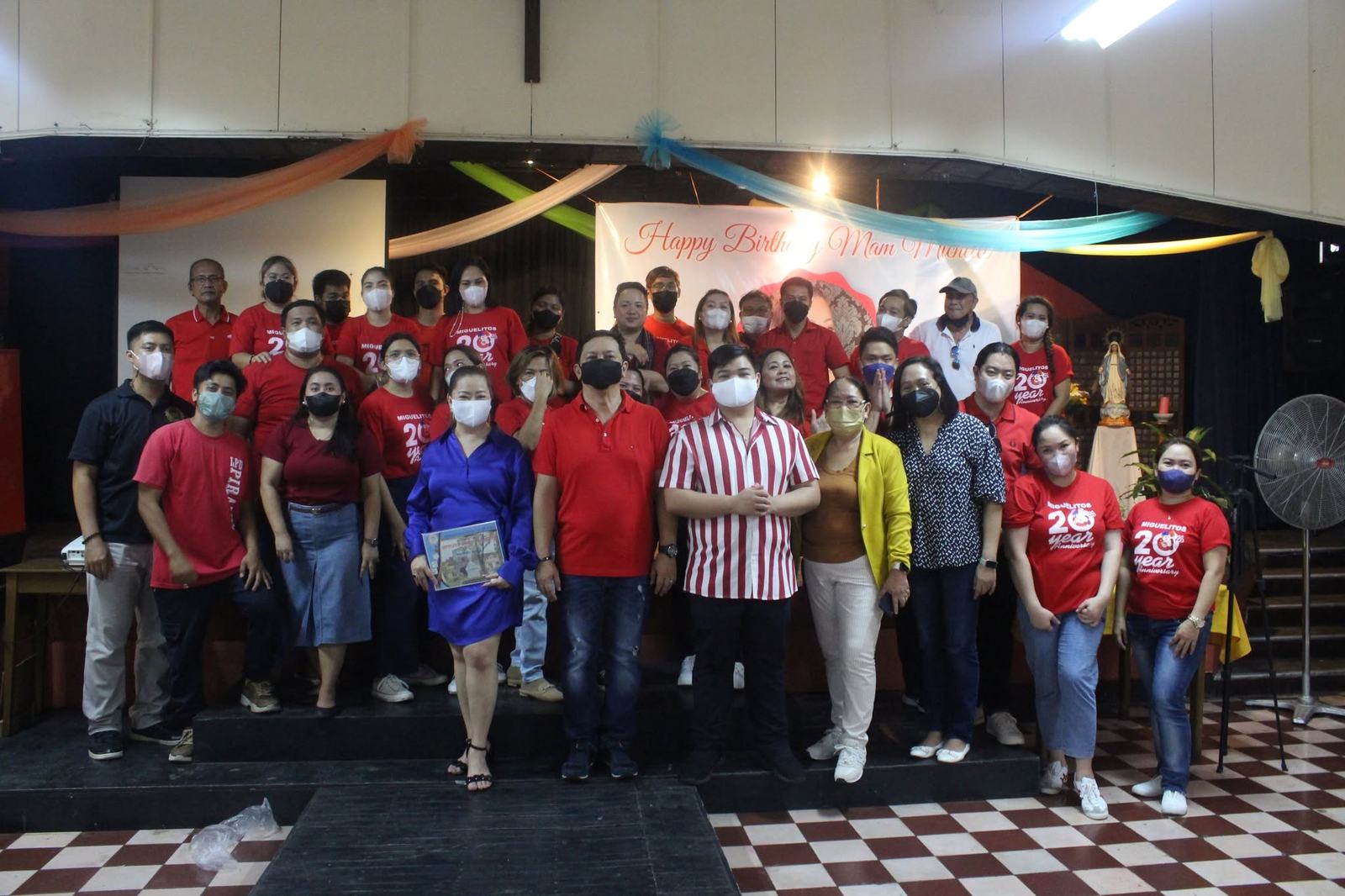 Volunteers gathered for a group photo at a community hall