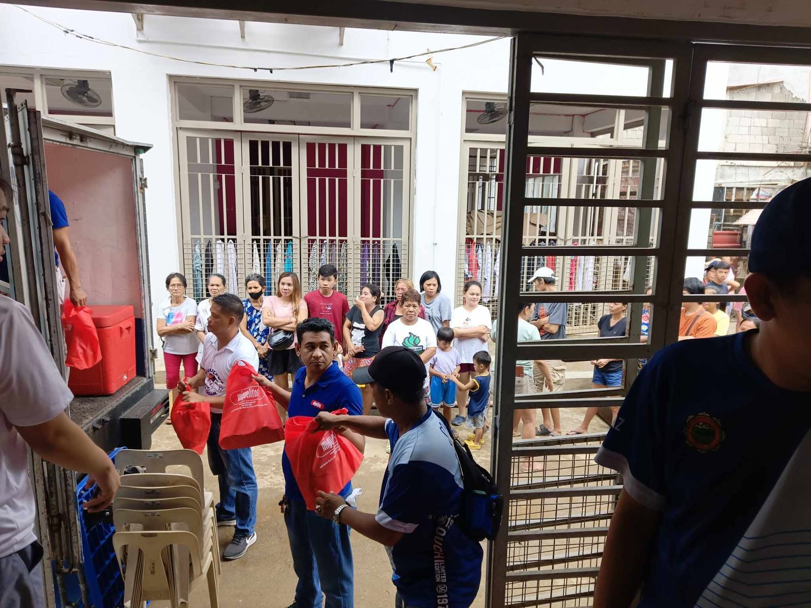 Volunteers handing out relief bags