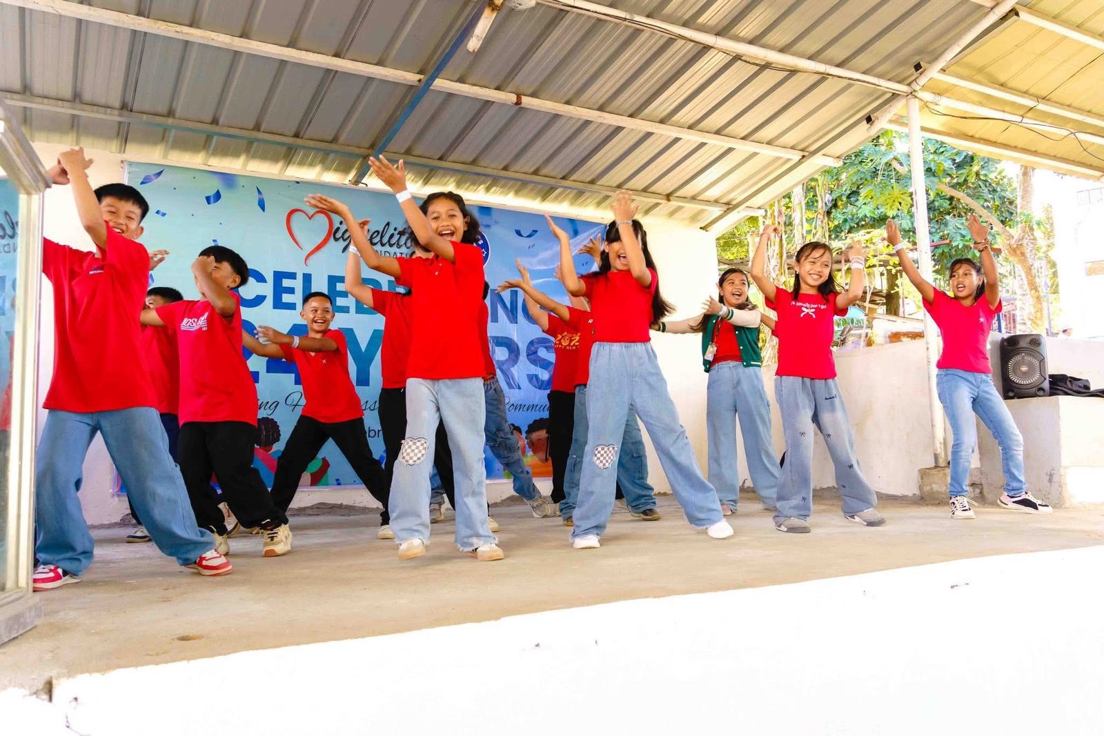 Kids dancing on stage at a community event
