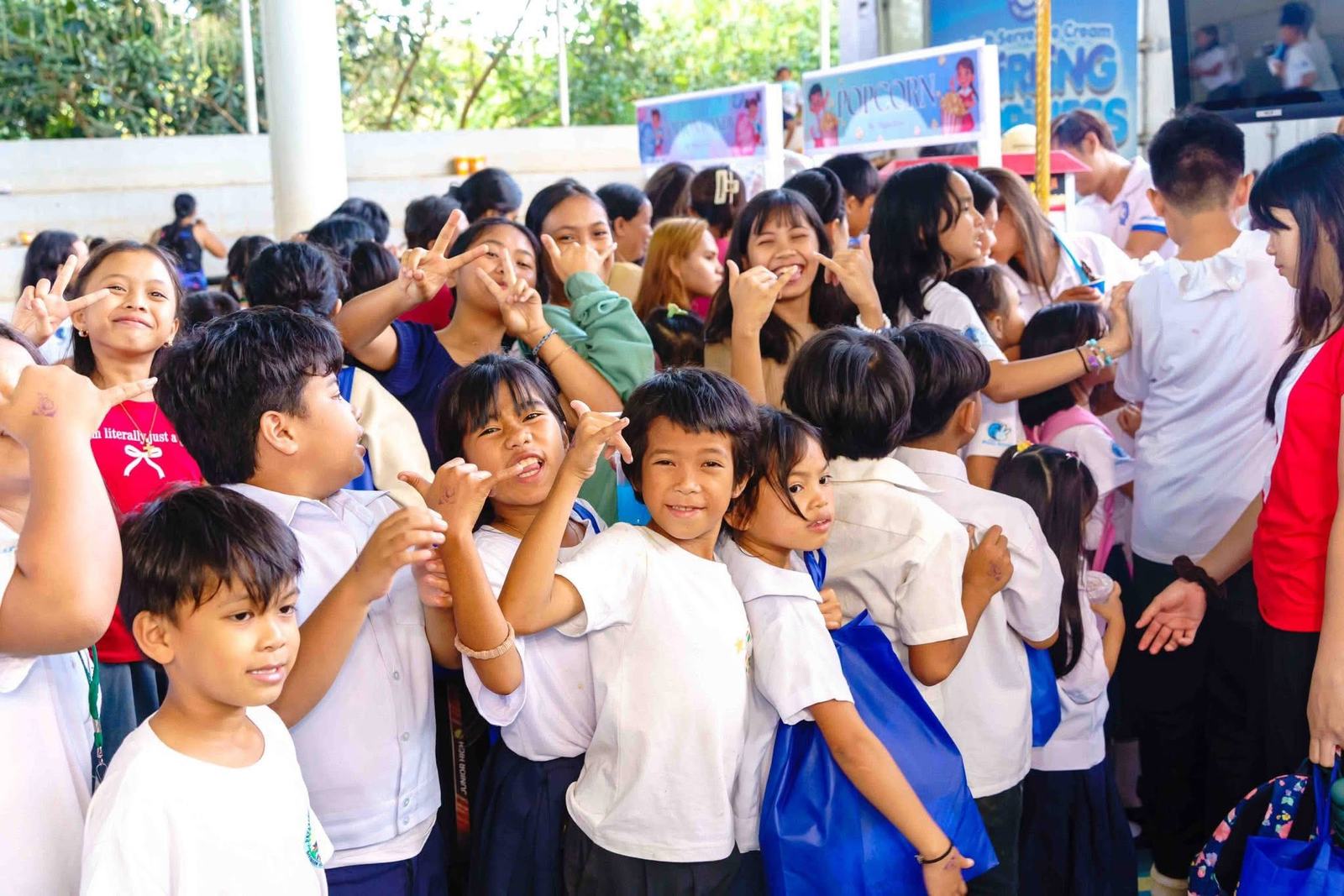 Children at a Miguelitos Cares outreach cheering together