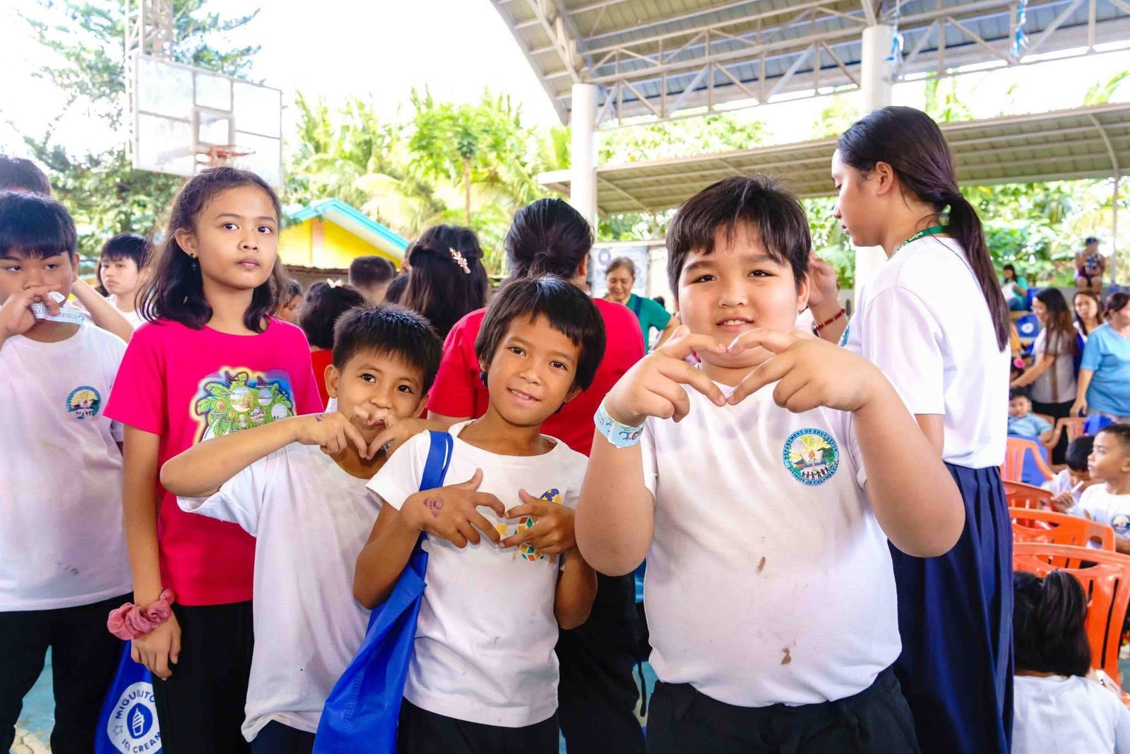Students making heart shapes with their hands