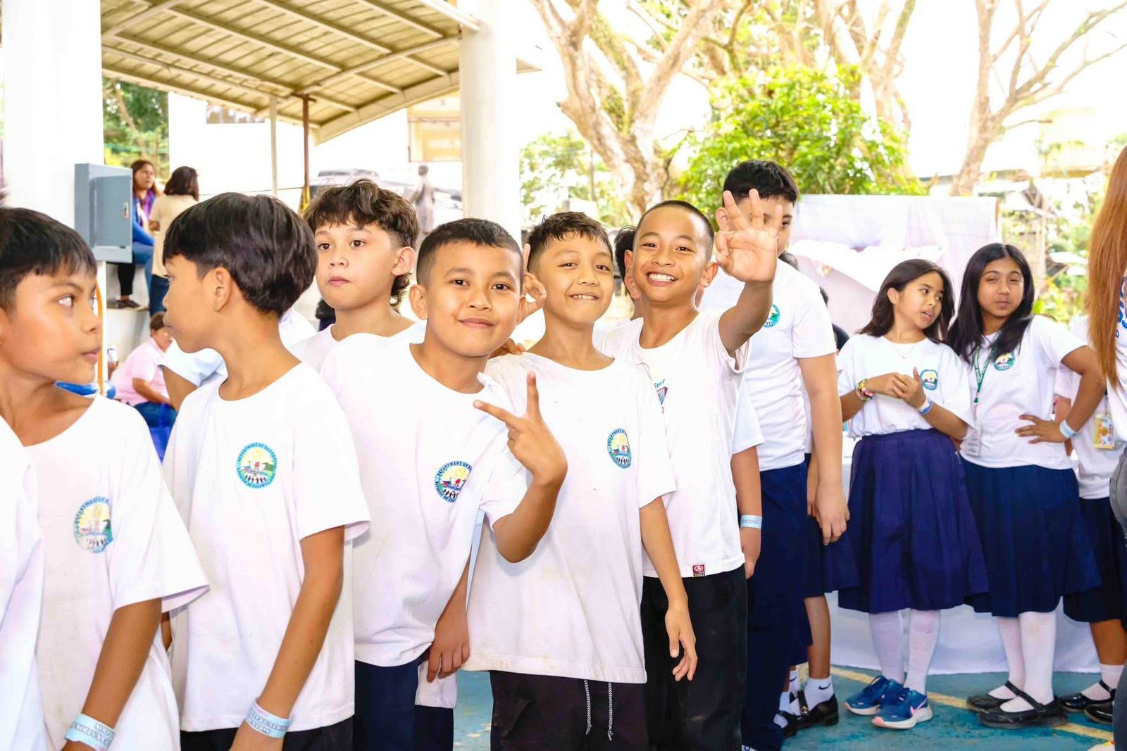 Students smiling and waving at the camera